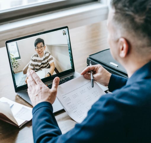 portrait of a man in a vido meeting using his pc